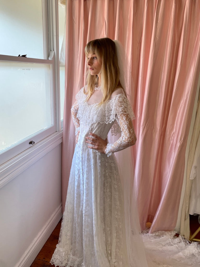 Vintage 80s dramatic lace long sleeve wedding gown with train